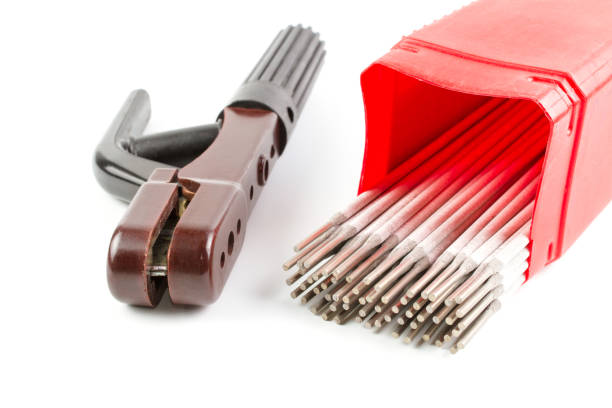 White Covered Arc Welding electrode for Steel in red plastic box and brown holder isolated on white background.
