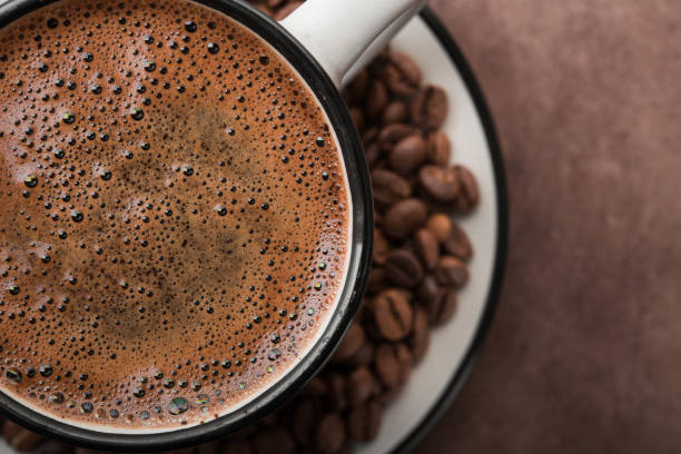 istock Coffee in a white cup with roasted beans 957350390