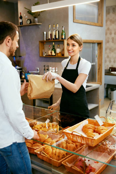 istock Bakery. Woman Working, Selling Bakery To Male 957350438