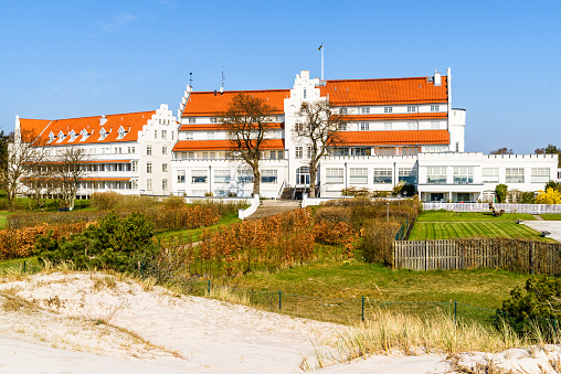 Falsterbo, Sweden - April 28, 2018: Travel documentary of everyday life and place. The Falsterbohus luxury hotel, now turned into a condominium. Here on a sunny spring day seen from the coast.