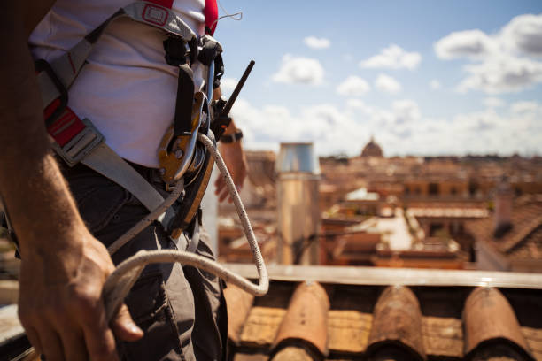 istock Manual workers in action on the roofs of Rome 957351410