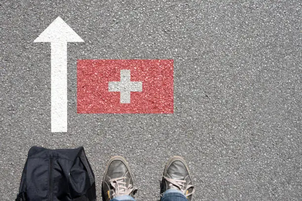 Photo of A man with a suitcase travels to Switzerland