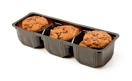Chocolate cookies packaged in a brown plastic container isolated on a white background