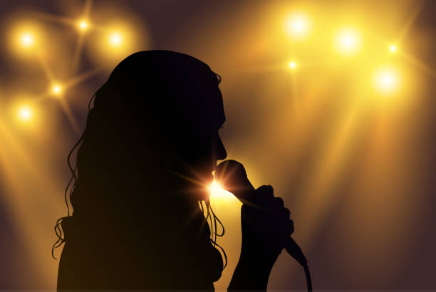 ilustrações de stock, clip art, desenhos animados e ícones de vector black silhouette of female singer with yellow spotlights in the background - microphone stage music popular music concert