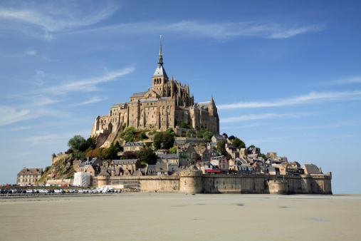 Mont Saint Michel with the Abbey church built above the hill during low tide in northern France