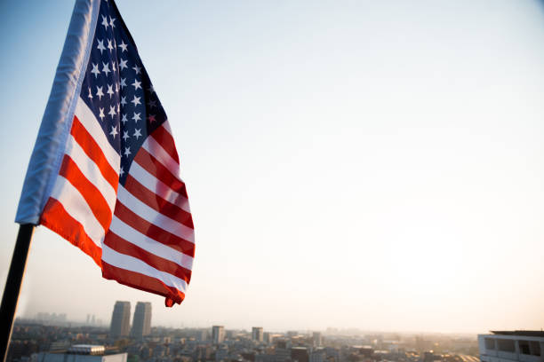 istock American flag waving in sunset 957365150