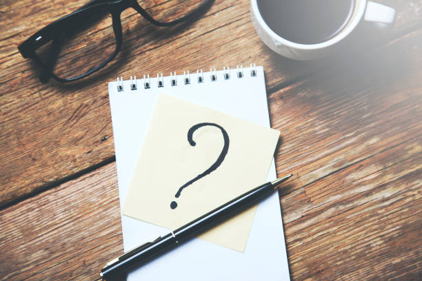 istock question mark on paper with cup of coffee 957365270