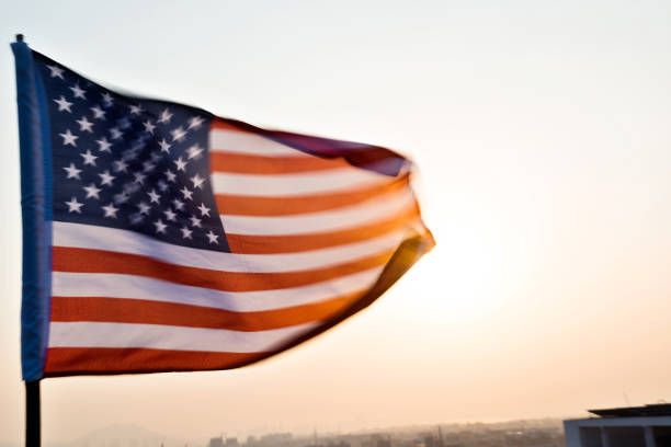 istock American flag waving in sunset 957365282