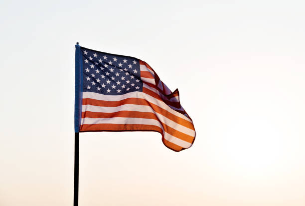 istock American flag waving in sunset 957365290