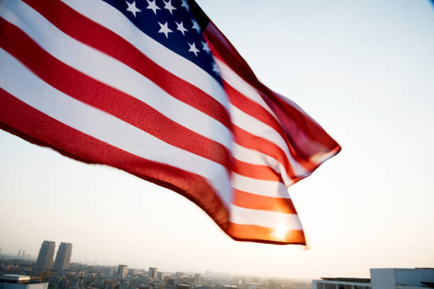 istock American flag waving in sunset 957365388