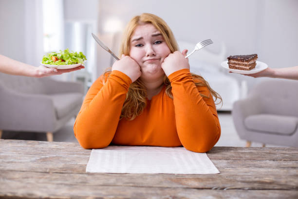 istock Desolate overweight woman being on a diet 957369052