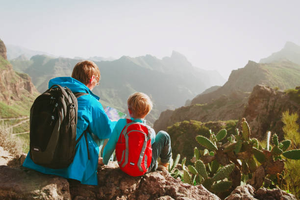 istock father and son travel in mountains 957369074