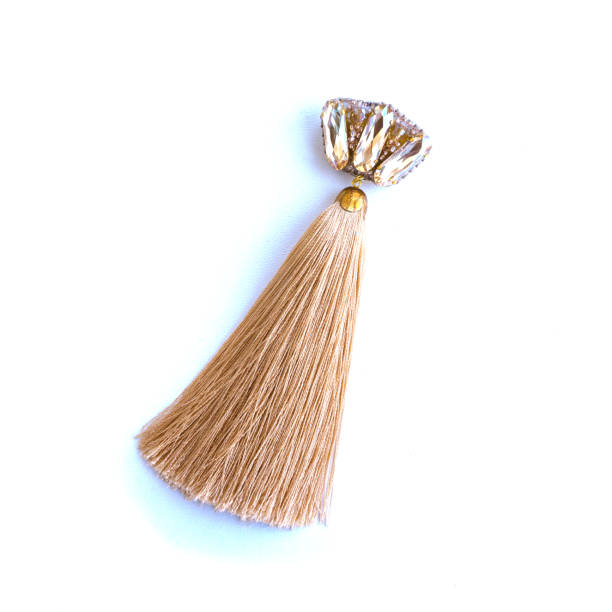 istock Handmade elegant brooch with a brush from silk threads and a rhinestone. 957372718