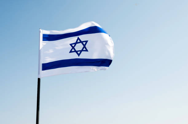 istock Israel's national flag in the wind 957379178