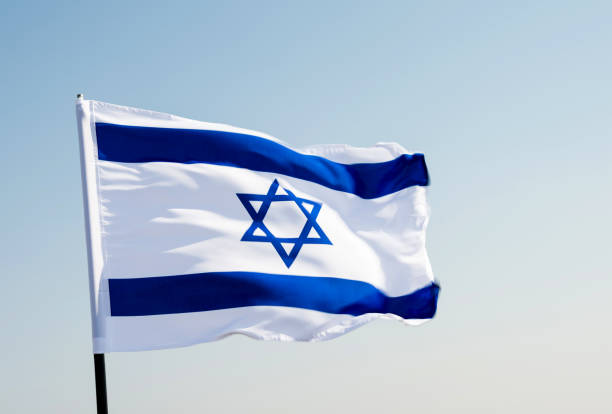 istock Israel's national flag in the wind 957379182