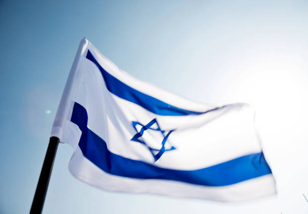 istock Israel's national flag in the wind 957379254