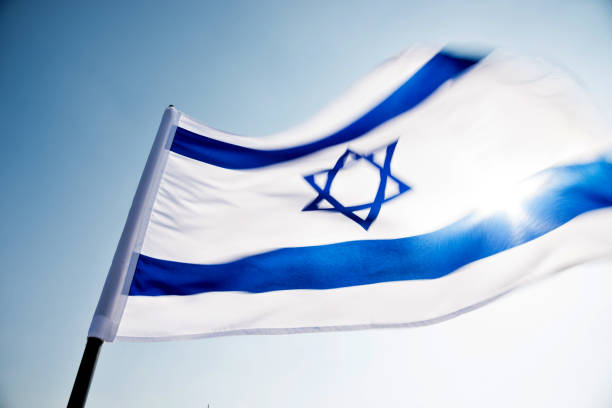 istock Israel's national flag in the wind 957379268
