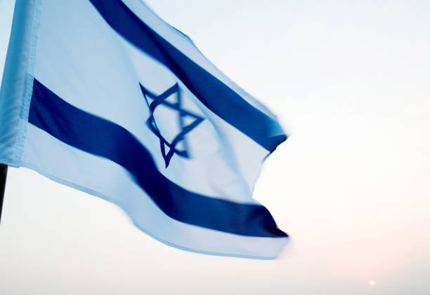 istock Israel's national flag in the wind 957379770