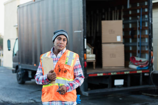 istock African-American man working, with delivery truck 957379788