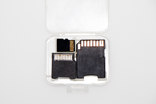 Memory cards in a transparent plastic case on a white background.