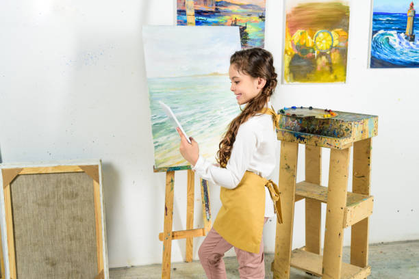 istock side view of kid using tablet in workshop of art school 957383236
