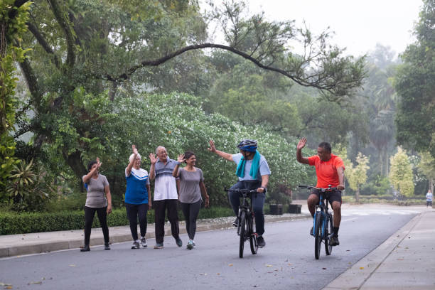 istock Group of active seniors greet each other in the park 957384372
