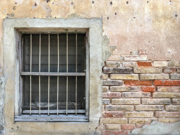 istock old rustic wood frame with metal bar and glass louver in cracking brick wall 957384522