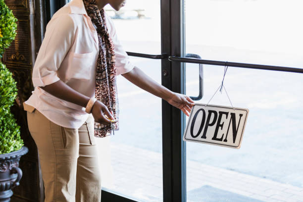 istock African-American woman opening store, turning sign 957386830