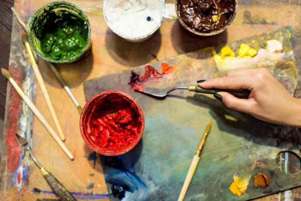istock cropped image of artist applying paint on palette in workshop 957387704