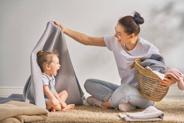 istock family doing laundry at home 957387762