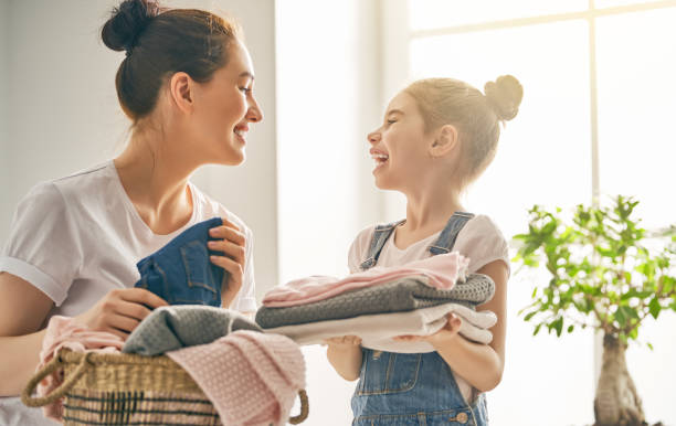 istock family doing laundry at home 957387782