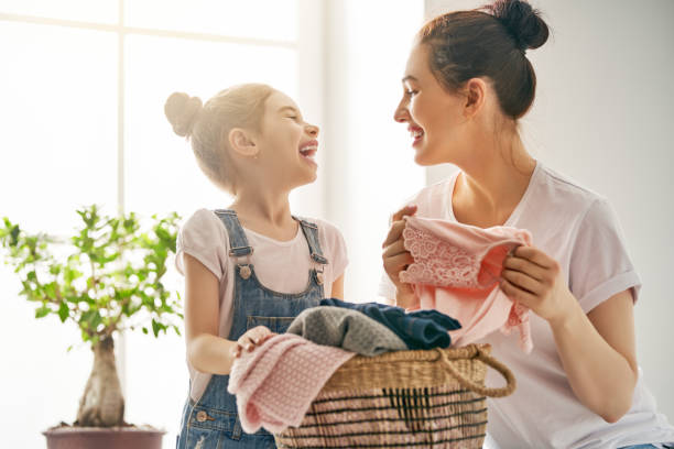 istock family doing laundry at home 957387800