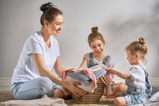 istock family doing laundry at home 957387854