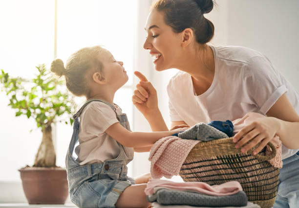 istock family doing laundry at home 957388474