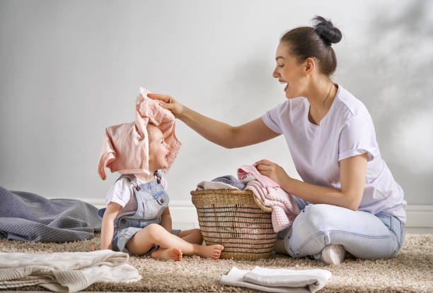 istock family doing laundry at home 957389968