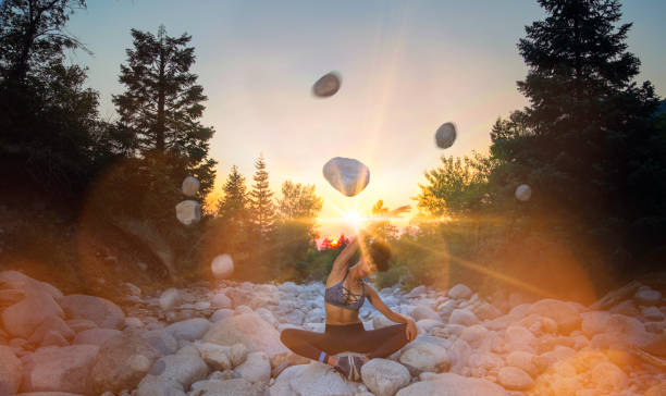 Woman doing yoga and floating rocks