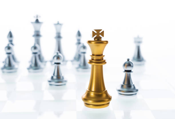 istock Golden king in front of silver chess pieces 957392850