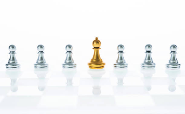 istock Golden and silver pawns are on the board 957393890