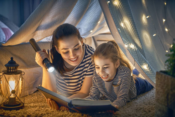 istock Mom and child reading a book 957394132