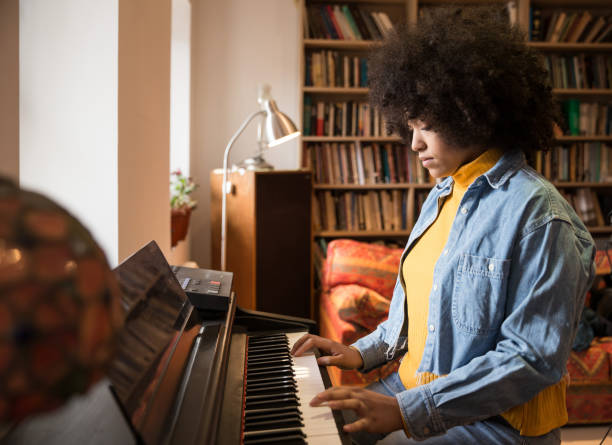 istock Sad young woman playing piano 957397944