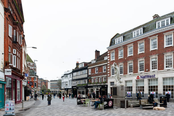 Kingston Market Place, town centre with lots of shops and stores in old buildings Kingston upon Thames, United Kingdom - April 2018: Kingston Market Place, town centre with lots of shops and stores in old buildings borough district type photos stock pictures, royalty-free photos & images