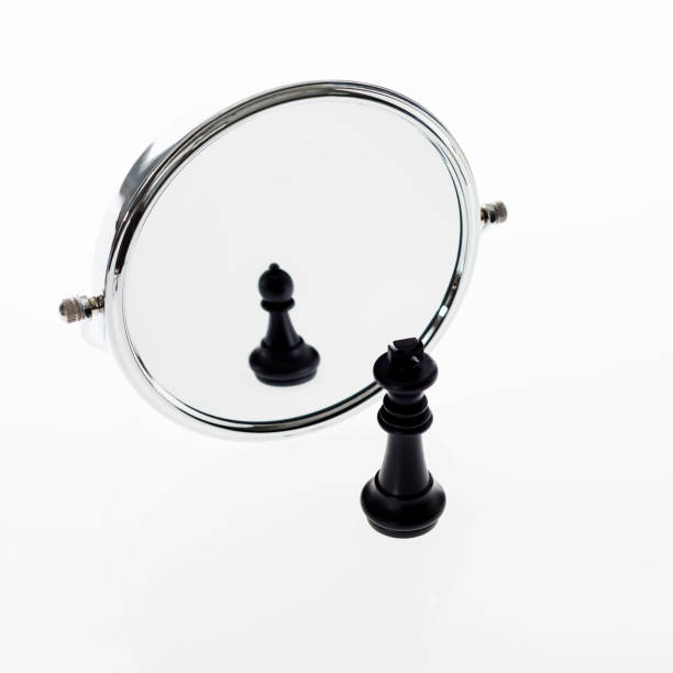 istock Black chess king imagining itself as a pawn 957404958