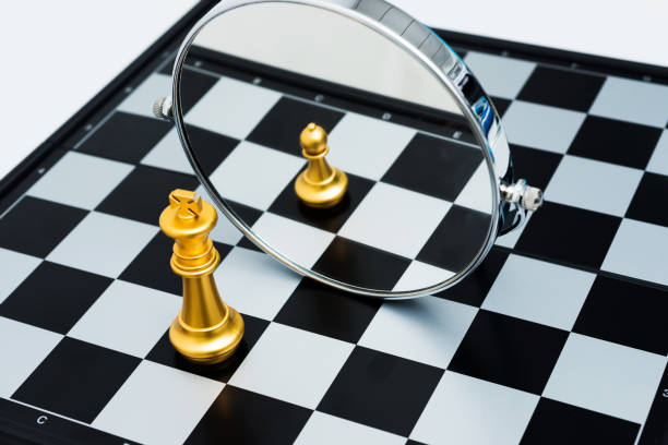 istock Golden chess king imagining itself as a pawn 957407290