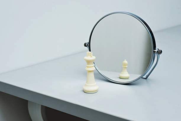 istock White chess king imagining itself as a pawn 957407296