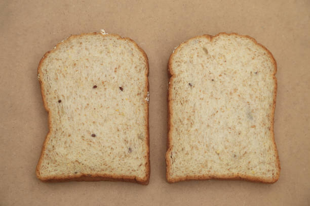 istock Whole grain breads on natural brown texture background. 957408120