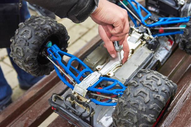 istock Man is repairing Radio-controlled car 957411018