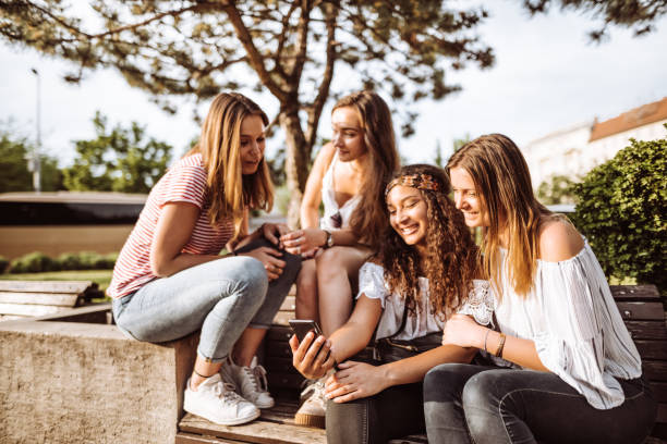 istock teens friends using the smartphone in the city 957411090