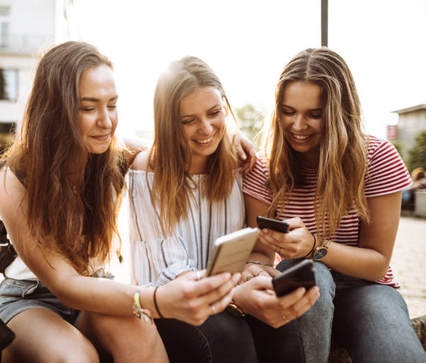 istock teens friends using the smartphone in the city 957411098
