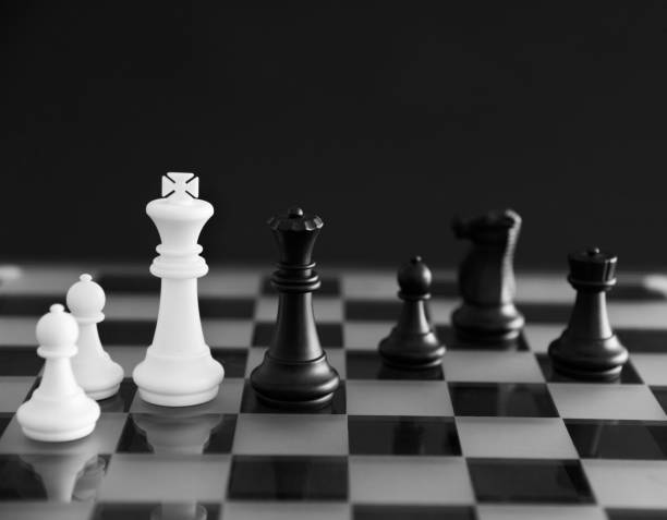 istock Black and white pieces on a chessboard 957411692