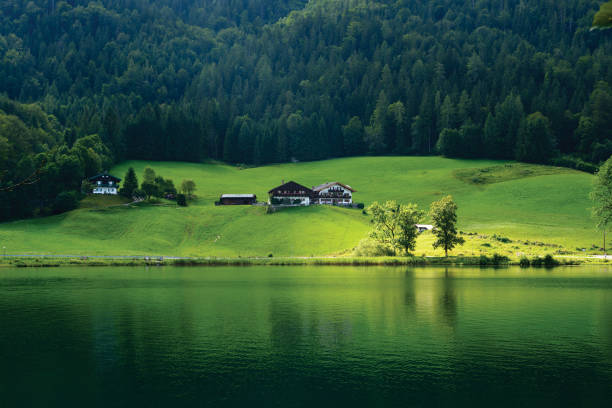 istock Countryside, houses by the water 957411892